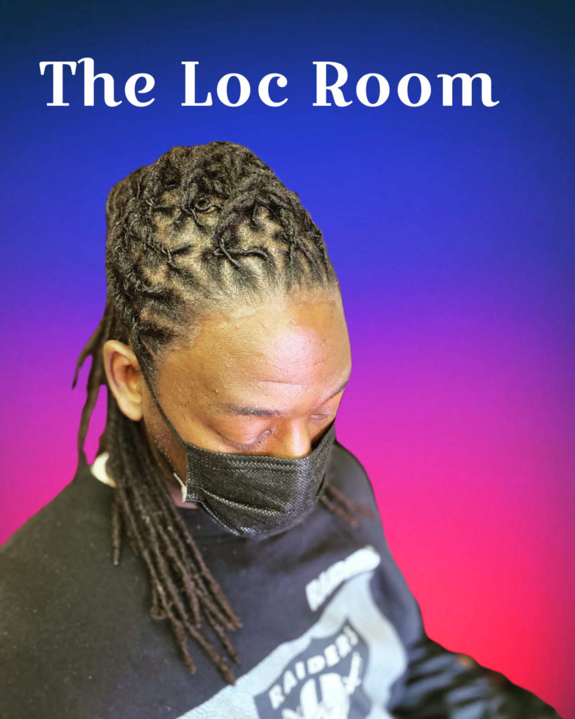 Client of the Loc Room Modeling a Styled Loc Re-twist while wearing a facemask